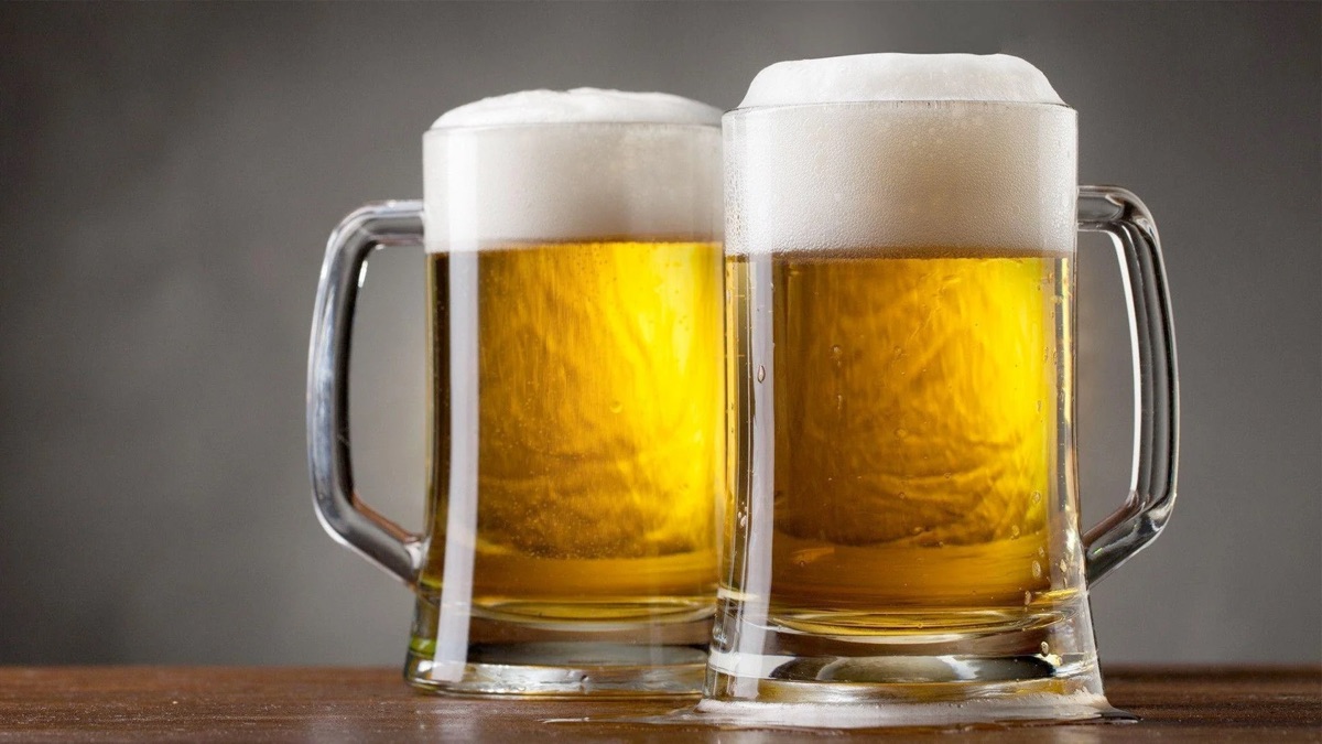 Two mugs of cold draft beer