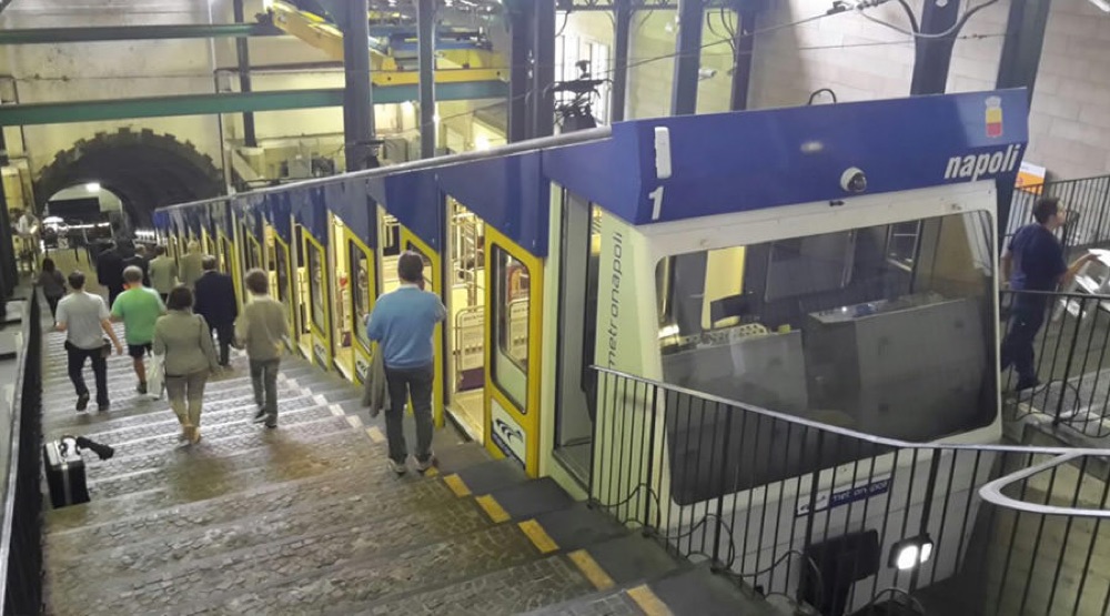 Passengers boarding a Naples funicular car at the station